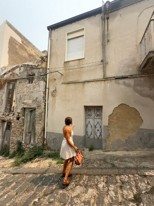 Standing in front of the home of my maternal Great Great Grandmother did something to my heart I can’t quite describe. 

On the long drive to the very small town of Grotte, Sicily I remember thinking “how lucky am I”— to be able to return to the other side of the world where part of me began. I simply wanted to be there. I wanted to see and feel this place that my Grammy came from— I needed to do it for my mom, my family, and especially to honor my grandmother who embodied so much I am striving to become. 

We went to the municipality and wandered around— it was seemingly empty. As we were leaving, a man came into the corridor. Ryan told him we were hoping they may have record of my family who was from there. We weren’t sure if he understood, then he waved us to follow him, and led us out and around the side of the building— into a separate entrance we never would have found. 

He spoke with a woman who ushered us behind her counter and into a room of record keeping. I showed her screenshots of my family’s names and death years. She went to a shelf and returned with books bound in the 1800s. 

My Google Translate wasn’t working well, but through broken translations and a beautiful energy that transcended all the words we wanted to say, I was shown the original hand written birth records of my family. These records held so much information that we didn’t previously have— including addresses. 

This angel of a woman wrote down an address and animatedly told us— the house still stands! And it’s right here. Just a few blocks away. And it turns out, my Grammy’s grandparents grew up one block away from each other. 

Walking hand in hand with my love on the same cobblestone streets they walked, being in the place where they fell in love, where they worked, sang, danced, ate, cried, and experienced every nuance of what colors a human life.. I was overwhelmed with gratitude for their sacrifices and a deepened perspective of my own life that I still struggle to put into words. 🥹🙏🏼

Photos from our time in 
Ortigia
Noto
Vendicari
Palazzolo
Grotte 
Valley of the gods 
Agrigiento 

Next: Taormina✨
