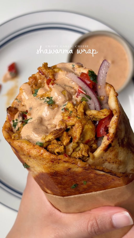 Crispy garlic cheese shawarma wrap 🌯 

Ingredients 

For the chicken:
2 lb boneless chicken breast and thighs mix, cut into small pieces 
Salt to taste 
1 tsp black pepper 
1 tbsp garlic powder 
1 tsp onion powder 
1 tbsp paprika powder
1 tsp sumac powder 
1 tsp cumin powder 
1-2 tsp red pepper flakes 
2 tbsp whole milk yogurt 
1 tbsp extra virgin olive oil 
1 tbsp lemon juice 
1 cup shredded mozzarella cheese 
1 tsp parsley 
Oil for cooking 

For the salad:

1 red onion, thinly diced
1/2 cup tomato, diced
1 tbsp parsley, finely chopped
Salt to taste
1/2 tsp black pepper 
1/2 tsp sumac 
1 tbsp lemon juice 
1 tbsp extra virgin olive oil 

For the creamy garlic sauce 

1/2 cup mayonnaise 
1/4 cup sour cream 
2 cloves fresh garlic
1 tbsp lemon juice 
Salt to taste
1/2 tsp black pepper 
1/2 tsp honey
1 tbsp paprika powder 
1 tsp garlic powder 

To assemble:

6-7 Thin pita wrap

Method:

Mix chicken with salt, pepper, garlic powder, onion powder, paprika, sumac, cumin, red pepper flakes, yogurt, olive oil and lemon juice. Coat well and marinate for at least 30 minutes, or refrigerate for a few hours.
For the salad, mix onion, tomato and parsley. Season with salt, pepper and sumac, then toss with lemon juice and olive oil.
For the sauce, blend mayonnaise, sour cream, garlic, lemon juice, salt, pepper, paprika, garlic powder and honey in a blender until smooth.
Heat a little oil in a large skillet over medium-high heat. Cook the chicken in batches without overcrowding until golden brown, crispy around the edges and cooked through.
Return all the chicken to the pan, top with mozzarella and cover for 1–2 minutes until melted. Toss gently and sprinkle with parsley.
Warm the pita, spread with garlic sauce, then add the cheesy chicken and salad.
Fold tightly and place seam-side down in a lightly oiled skillet over medium heat. Toast both sides until golden, crispy and the cheese is melty.
Cut in half and serve with extra garlic sauce.

#recipe #shawarma #garlicchicken