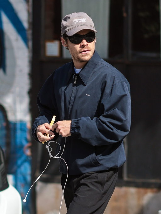 Ready, steady, go: Harry Styles takes a leisurely fall stroll between his Madison Square Garden residency dates in a Prada blouson jacket. See our fall favorites at the link in our bio.