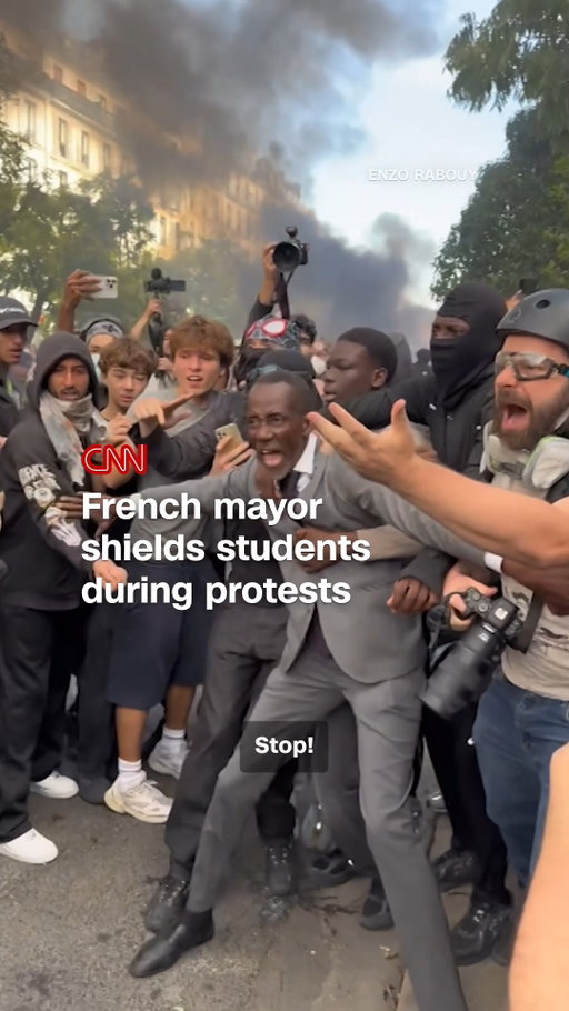 The mayor of a Parisian suburb was seen stepping between protesting students and riot police as protests over education funding continue in France.