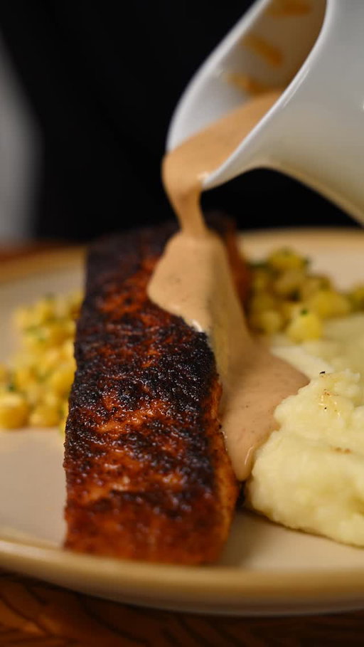 Cheesecake Factory at home! Cajun blackened salmon, buttery mashed potatoes, sweet corn, and a rich Cajun cream sauce. So good!

Cajun Blackened Salmon

* 2 salmon fillets
* Cajun seasoning
* Olive oil + neutral oil

Coat salmon with olive oil and generously season with Cajun spice. Sear in a hot pan with neutral oil, using a weight for maximum contact and a deep, blackened crust. Flip, cook about ¾ of the way through, and set aside.

Creamy Mashed Potatoes

* Yukon Gold potatoes
* Butter + heavy cream
* Salt

Peel and cut potatoes, then start in cold, generously salted water. Boil until tender, drain, and rice. Fold in warm melted butter and cream, whip until smooth, and season to taste.

Buttered Corn

* Fresh corn, kernels removed
* 1 tbsp butter
* 1 tbsp chopped chives
* Salt

Add corn to a pan with a splash of water. Cover and steam until nearly evaporated, then toss with butter, chives, and salt.

Cajun Cream Sauce

* Butter
* Shallots + garlic
* Chili flakes
* Heavy cream
* Cajun seasoning + paprika
* Lemon juice

Pour off excess oil from the salmon pan. Add butter, shallots, garlic, and chili flakes. Sweat until fragrant, then add cream, Cajun seasoning, and paprika. Simmer until slightly thickened and finish with lemon juice.

Plate the mashed potatoes, add buttered corn and blackened salmon, then finish with a generous drizzle of Cajun cream sauce. Enjoy!

#easyrecipes #cheesecakefactory #cajunsalmon