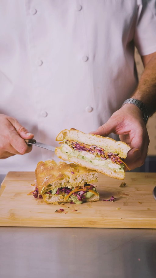 Meet Sebastian Mentil the culinary development chef responsible for your favorite Whole Foods hot foods items and more! Each week in October he will be sharing some of his favorite go-to recipes, all made with produce available right now in our stores:

This week it’s Loaded Paleo Chicken & Seasonal Slaw Focaccia

The Ingredients: Toasted Focaccia, Paleo chicken breast, shredded seasonal slaw (celeriac, apple, carrot, red cabbage) scruncied in a hot honey-lemon dressing, homemade Green Goddess dressing, crispy onions, and grated parmesan. 

The Method: Whisk up a fresh Green Goddess dressing by blending herbs (parsley, dill, tarragon, chives, mint), avocado, garlic, mayo, sour cream, and lemon. Massage the slaw veggies with hot honey and lemon juice. Toast the focaccia, coat both sides with Green Goddess dressing, layer on tossed chicken, slaw, crispy onions, and parmesan before slicing.