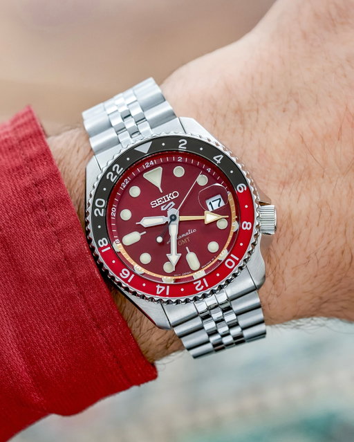Seiko is adding a new U.S. Limited Edition to its popular Seiko 5 Sports SKX GMT collection for 2026. Reference HDB016 introduces a deep maroon sunray dial and a bidirectional 24-hour bezel in red and dark brown, offering a fresh color combination within an already diverse lineup.

Its 42.5mm stainless steel case retains the familiar SKX silhouette and 4 o’clock crown placement. A dedicated GMT hand can be adjusted independently to track a second time zone, giving the watch its practical caller GMT functionality. Luminous hands and markers improve visibility in low light, while 100 meters of water resistance and a stainless steel bracelet add everyday versatility.

Inside, Seiko’s automatic Caliber 4R34 delivers a 41-hour power reserve and can be viewed through an exhibition caseback. While the mechanics remain familiar, this latest release adds another distinctive option to the growing SKX GMT collection.

We’re thinking this one needs a nickname. Perhaps “Dr. Pepper”? What would you call it?