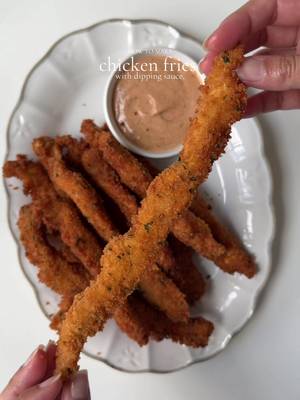 Crispy chicken fries with chicken sauce. Ingredients  For the chicken: 2 lb boneless chicken breast, cut into long strips  Salt to taste 1 tbsp black pepper  1 tsp salt 1 tsp onion powder  1 tbsp smoked paprika powder  2 tbsp oil For the dry batter: 2 cup all purpose flour  Salt to taste  1 tbsp garlic powder  1 tsp onion powder  1 tbsp smoked paprika powder  1 tsp black pepper  For the breadcrumbs: 2 cup panko bread  1 tbsp dried parsley  For the egg wash. 1 egg 1 cup water For the chicken sauce  1 cup mayonnaise  2 tbsp ketchup  1 tbsp Worcestershire sauce  Salt and pepper to taste  1 tbsp garlic powder  1 tsp smoked paprika powder  Method : Pat dry the chicken strips add them into a mixing bowl.  Season with salt pepper, paprika, onion and garlic powder. Drizzle oil , mix well and marinate for about 1 hour in refrigerator. Make dry batter: in a bowl add All purpose flour Salt, pepper, paprika garlic and onion powder . Mix to combine  Make egg wash: In a bowl crack an egg add water and whisk to combine  In a separate tray add bread crumbs and parsley. Mix to combine. Coat the chicken in dry batter then in egg mixture, repeat by coating in dry and egg and lastly coat them with breadcrumbs. Lay flat on a sheet and repeat until all the chicken strips are coated. Make sauce by mix mayonnaise, ketchup, Worcestershire sauce, salt pepper, garlic powder smoked paprika.  Heat oil at 350 F . Carefully drop chicken strips into the hot oil cook for 2-3 min or until internal temp reaches 165 and they turn golden and crispy.  Serve with chicken sauce and enjoy  #fries #crispychicken #Recipe 