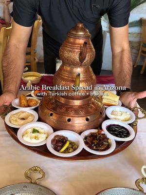 🍳🧆 Definitely a unique spot in Gilbert is Rayoog Cafe. This was my first time having Arabic and Turkish breakfast with this beautiful breakfast spread (called Special Mam’s that includes hummus, salad, baba ghnogh, yogurt, shakshuka eggs, and more). Definitely order the Turkish coffee and baklava with ice cream, Nutella and pistachio to finish off your meal. This can feed 2-3 people for sure and we had plenty of leftovers after. Highly recommend if you’ve never been!   @rayoogcafe  📍 78 N Cooper Rd Ste 101, Gilbert, AZ 85233  #gilbertarizona #arabicfood #turkishfood 
