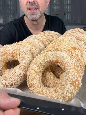 Gevrek 800 grams plain flour 500 mils lukewarm warm water 2 sachets (14 grams) instant dried yeast 1 pinch of salt 1 teaspoon salt Add the yeast into the water with sugar and mix, let it sit for 15 min. In a bowl add the flour and salt, add the liquid while stirring in and once all water added knead by hand for 15 minutes. Cover and let it sit for 40 min to an hour. Divide dough into 16 even balls. Create the Gevrek shape as per the video.  In a pot add 2 litres of water, bring to the boil and add 6 tablespoons honey until dissolved. Cook gevrek for 3 minutes and then dip into sesame seeds and bake for 25-30 minutes. #georgegeorgievski #gevrek