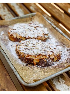 Lazy almond croissant exists and it’s called Bostock. All you do is slice up your day-old challah into thick pieces, soak them in syrup, spread on a creamy almond frangipane made with @Organic Valley butter and eggs, sprinkle with sliced almonds, bake, dust with powdered sugar, and boom-your whole house smells like a French bakery. Honestly? I’d pick this over an almond croissant 10,000 times out of 10. Full recipe is on my website BenGingi.com  Challah recipe is in our cookbook EAT SMALL PLATES (out in a week from today, 9/9) YASSS!