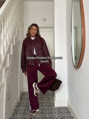 The way burgundy outfits have me in a chokehold 😮‍💨  These adidas loose firebird track pants in burgundy are so perfect for autumn. I love them worn as a casual autumn outfit but also dressed up with some heeled for a more relaxed evening look.  @adidas @DeMellier @TOPSHOP TOPMAN  #burgundyoutfit #adidasfirebird #adidastrackpants #autumnoutfit 