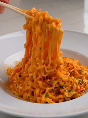 Cheesy Spicy Ramen Sometimes all I need is a bowl of noodles like this.  @Jin Ramen by OTOKI Cheddar & Mascarpone noodles, tossed them in a gochujang cream sauce, and finished with mozzarella. Kinda like mac & cheese meets ramen. #cheesyramenpartner  Ingredients 2 packs Otoki Cheddar & Mascarpone Cheese Ramen 3 tbsp cooking olive oil (or other neutral cooking oil) 1 shallot, finely chopped 3-4 garlic cloves, minced 1 1/2 tbsp gochujang (or double-concentrated tomato paste for a non-spicy option) 1/4 cup water or vegetable stock 3/4 cup heavy cream 1/3 cup shredded mozzarella or fontina cheese Fine sea salt, if needed For serving 2-4 tsp chili oil (about 1 tsp per serving, optional) 3 tbsp chopped chives or parsley Instructions: Bring a medium pot of salted water to a boil. Meanwhile, heat the cooking olive oil in a large skillet over medium heat. Add the shallot and sauté for about 2 minutes, until translucent. Add the garlic and cook for another 30-60 seconds, stirring constantly to avoid burning. Stir in the gochujang and cook for 30 seconds. Add the water or vegetable stock, stir well, and let simmer until slightly thickened, about 1-2 minutes. Lower the heat to medium-low. Stir in the heavy cream and simmer gently for 2-3 minutes, until the sauce begins to thicken. Add the ramen noodles to the boiling water and cook for 1-2 minutes less than the package instructions. Reserve 1/2 cup of the noodle cooking water. Transfer the noodles to the skillet with the sauce. Add the cheese seasoning packet from the ramen, along with 3 tbsp of the reserved noodle water. Increase the heat to medium and toss the noodles in the sauce for about 2 minutes, until fully coated and just cooked through. Taste and adjust salt, the seasoning packet may already be enough. Sprinkle the shredded mozzarella (or fontina) over the noodles. Turn off the heat and let the cheese melt into the sauce. Divide the ramen into bowls and top with chili oil and chives. Serve immediately. Notes: If the sauce becomes too thick, loosen it with a splash of reserved noodle water or extra heavy cream. For a less spicy version, replace the gochujang with tomato paste. #creamyramen #otoki #cheesyramen #EasyRecipe  Cheesy ramen, easy recipes, spicy noodles recipe, creamy gochujang sauce