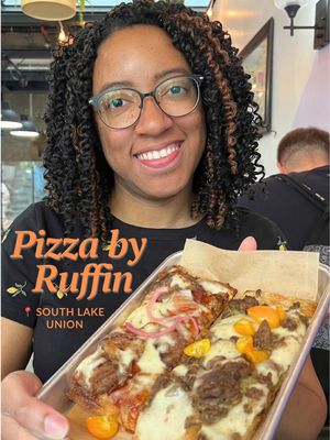 Washington State’s first Black-owned pizzeria is here and they’re serving delicious Roman-style slices. I’d followed @Isaiah Ruffin and Colleen’s journey to opening Pizza by Ruffin here on TikTok. On a rare weekday off, I got to stop by for lunch.  Standout slices for me were the bbq brisket and lamb. My fiancé tried the gotchu-Jane, which was a special. The pizza crust was perfect and I can honestly say lunch was delicious. I just wish I could visit more often! Slices range about $7-$8 each and two slices were enough for me to feel full. Pizza by Ruffin is open on weekdays and be sure to arrive early as they sometimes sell out by late afternoon. Specials rotate weekly, so follow them to see what’s on the menu. This business is also nominated for an @Intentionalist award this year, and the ceremony is in October. Check out Pizza by Ruffin on your lunch break and if you’ve been to this Seattle spot before, tell me your favorite flavor. 🍕  📍Pizza by Ruffin - South Lake Union inside of the Fairview Market Hall  💵 Price range: $7-$8 per slice. This is an affordable lunch restaurant in Seattle! … … #seattle #seattlefoodie #blackinseattle #seattlerestaurant #pizza