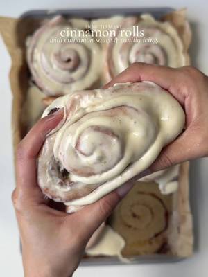 Cinnamon rolls with cinnamon sauce and vanilla frosting. Ingredients  Yeast mixture: 2 1/4 tsp instant dry yeast  1 1/4 cup whole milk, slightly warmed ( between 90-110 F).   1 tsp granulated sugar  For the dough: 4 1/2 cups all purpose flour  1 beaten egg, room temp 1 tbsp vanilla bean paste  6 tbsp salted butter , softened  1/3 cup granulated sugar  Yeast mixture  For the Cinnamon sauce: 5 tbsp unsalted butter, softened  1 tbsp cinnamon  1 tsp vanilla bean paste 2 tbsp heavy whipping cream  2 tbsp honey 1/3 cup light brown sugar  For the filling: 3/4 cup light brown sugar  2 tbsp cinnamon 1/2 cup unsalted butter, melted  For the frosting: 6 tbsp unsalted butter, softened  3/4 cup powdered sugar  1 tsp vanilla bean paste  6 oz cream cheese, room temp 3 tbsp milk ( less or more to adjust the consistency ) Method: In bowl add warmed milk , instant yeast mix, sugar. Mix and leave for 10 min or until bloomed. In a stand mixer bowl or mixing bowl add 2 cups all purpose flour, sugar and salt. Mix well to combine. Add in softened butter, egg, yeast mixture, vanilla beans paste. Mix with dough attachment hook or by a spoon for 2-3 until combined. Add in rest of the flour. And knead the for 8-10 min until a smooth dough ball forms. Place in a greased bowl , cover and leave it in a warm place for 1 hour or until it doubles in size. Prepare the cinnamon sauce by mixing softened butter, cinnamon, brown sugar, honey, vanilla bean paste and heavy whipping cream.  Prepare the cinnamon filling by mixing cinnamon and brown sugar until well combined. Once the dough doubles in size roll it out into rectangular shape(1/4 inch thick). Spread melted butter on top. Sprinkle cinnamon sugar evenly all over. Roll it out tightly into a long log, cut  10-12 equal size rolls with a sharp knife or thread. Take a baking dish and spread Cinnamon sauce evenly on the bottom. Place rolls on top, cover and leave them in a warm spot for 30 min to proof again. Prepare cream cheese frosting by whisking butter, cream cheese, powdered sugar, vanilla and milk until smooth and creamy.  Preheat oven to 350 F . Bake the buns for 28-30 min or until golden brown. Let cool for 15 min before frosting and enjoy. #cinnamonbuns #cinnamonrolls #cinnamon #Recipe 