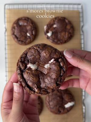 S’mores Brownie cookie 🍪  Ingredients: 3/4 cups (90g)  all purpose flour  6 tbsp (84g) unsalted butter, cubed 2 large egg, room temp 1/3 cup (67g)granulated sugar  1/3 cup light (73g) brown sugar  3/4 tsp baking powder  1 tbsp vanilla bean paste  5 tbsp (40g) unsweetened natural cocoa powder  1/2 tsp salt 4 oz (113g) semi sweet chocolate chips + more for topping  8 small graham cracker squares  8 large marshmallows  1 tsp instant coffee, optional  Method: Preheat oven to 350 F. Line a baking sheet with parchment paper. Melt chocolate: In a heatproof add butter and chocolate chips. Heat in 30 sec intervals, stirring between each interval. Total of 1 minute and 30 sec, or until melted and smooth. Set aside . Make wet batter: In a separate bowl crack egg, add brown sugar, whisk for 2-3 min by hand or by mixer until sugar is completely dissolved in the egg, add in the granulated sugar. Whisk for another 1 -2  minute until the sugar is completely dissolved and the batter is light pale in color , add vanilla bean paste, mix. Pour in the chocolate mixture to the egg mixture mix. Whisk to combine  Make dry batter: In a separate bowl, combined dry ingredients by mixing all purpose flour, salt, instant coffee, baking powder, and cocoa powder. Mix to combine. Add dry ingredients to the wet batter. Mix until just combined do not over mix the batter at this point. The end result would be thick batter like consistency. Place graham cracker squares onto the parchment paper followed by marshmallows.  Scoop out brownie batter with an icecream scoop and pour 1 scoop on each marshmallow covering it evenly. Do not place more than 4 cookies on one baking sheet. Leaving about 3 inches of space between each cookie. Bake for 12-14 min or until the cookie is chewy and crispy from the sides and gooey fudgy from center. Let cool completely for 30-40 minutes before consuming and enjoy. #cookie #smores #smorescookies #cookies 