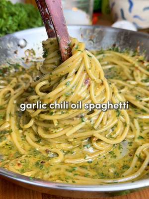 Garlic Chili Oil Spaghetti 🧄 (aka Aglio e Olio) Minimal effort, max flavor. Garlicky, lightly spicy, and impossibly comforting 🫠 Ingredients -8 oz (225 g) spaghetti -1/3 cup extra virgin olive oil (plus 1 to 2 tbsp more if needed) -8 garlic cloves, thinly sliced -1 tsp red chili flakes (or 1 tsp finely chopped fresh chili without seeds) -1 to 1 1/2 cups reserved pasta water -1 whole parsley stem (for infusing) -1/3 cup fresh parsley leaves, finely chopped -Fresh lemon zest, for garnish (optional) -Freshly grated Parmesan cheese, for serving (optional) Instructions 1.Bring a large pot of aggressively salted water to a boil. Cook spaghetti until al dente. Reserve 1 1/2 cups of the starchy pasta water, then drain. 2. While the pasta cooks, heat the olive oil gently in a large skillet over medium-low. Add the garlic slices and whole parsley stem, stir constantly until the garlic turns light golden… not brown (about 3 minutes) 3. Stir in the chili flakes and a pinch of salt. Let them bloom for 30 seconds, then remove the parsley stem and take the pan off the heat. 4.Add about ½ cup of the reserved pasta water to the skillet and stir/whisk vigorously to combine with the oil. It’ll start looking creamy and slightly thick… that’s your emulsion forming. 5. Return the pan to medium-low heat and add the drained spaghetti along with another splash of pasta water. Here’s the key: Toss everything aggressively with tongs for 1–2 minutes, drizzling in 1 to 2 more tablespoons of olive oil and a bit more pasta water as you go. Alternate between the two while tossing nonstop. The sauce should turn silky and glossy. If it looks dry or clumpy, add more water; if it looks thin, keep tossing. 6. Turn off the heat and stir in the chopped parsley. Taste and add a tiny pinch of salt if needed. 7. Plate immediately, spooning any extra sauce from the pan over the top. Garnish with lemon zest and a sprinkle of Parmesan if you’d like (add cheese after plating so it doesn’t break the emulsion… not traditional, but worth it 👀). #dinner #pasta #cooking #Recipe #recipesoftiktok #easydinner #recipesoftiktok #cookingathometiktoktv #italianfood 