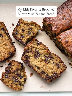 Day 2 of cooking in our temp kitchen while we renovate and I knew I wanted to bake something familiar and comforting to the kids. Banana bread might be the thing I make most — because rotting bananas, duh! 🤪 — and our favorite version combines nutty browned butter with sweet white miso paste. It is perfection and the kids can smell it from a mile away! Full recipe below, so be sure to save for when you too have 🍌 in utter despair. 💯 Ingredients: ▢ 10 Tbsp (142g) unsalted butter ▢ ¼ cup (60g) sweet white miso ▢ 2 cups (240g) all-purpose flour ▢ 1 tsp baking soda ▢ ½ tsp ground cinnamon ▢ ½ tsp kosher salt ▢ 2 or 3 large ripe bananas (because sometimes I have 2 and sometimes I have 3 😂) ▢ ⅔ cup (135g) light brown sugar ▢ ¼ cup (50g) granulated sugar ▢ ⅓ cup (90g) sour cream ▢ 2 large (100g) eggs, room temperature ▢ 1 tsp pure vanilla extract ▢ 1 cup (200g) semi-sweet chocolate chips or shaved chocolate 1. BROWN THE BUTTER. In a saucepan over medium heat, melt the butter and cook until golden brown and nutty, about 5–7 minutes. Pour into a heatproof bowl, then whisk in the miso paste until smooth. Let cool slightly. 2. MIX DRY INGREDIENTS. In a medium bowl, whisk together the flour, baking soda, cinnamon, and kosher salt. 3. COMBINE WET INGREDIENTS. In a large bowl, mash the bananas with a fork, as smooth as you can get them. Add the browned butter-miso mixture, brown sugar, granulated sugar, sour cream, eggs, vanilla extract, and vanilla bean seeds. Whisk until fully combined. 4. FINISH THE BATTER. Add the dry ingredients to the wet and fold gently with a spatula until just a few streaks of flour remain. Stir in the chocolate chips, being careful not to overmix. 5. BAKE. Pour the batter into a parchment-lined 9x5 loaf pan and smooth the top. Use a butter knife to draw a line down the center (this encourages an even rise). Bake at 350°F for 60 minutes, or until a toothpick inserted into the center comes out clean. 6. COOL AND SERVE. Let the banana bread cool in the pan for 10–15 minutes, then transfer to a wire rack. Slice and enjoy — optionally with a sprinkle of flaky sea salt on top. #bananabread #breakfastideas #EasyRecipe #fallbaking