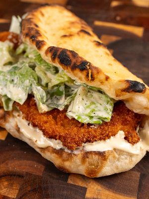 Crispy Chicken Caesar Pizza Sandwich Caesar salad and crispy chicken is a combo that’s hard to beat. Stuff it all inside folded pizza dough and it goes to another level. I used the Caesar dressing as the base of the sandwich, and together it made a heavenly bite. Full recipe on my website! #chickensandwich #foodieheaven #pizzalovers #fypp #EasyRecipe  crispy chicken sandwich chicken caesar pizza Easy recipe Easy comfort food American fusion food
