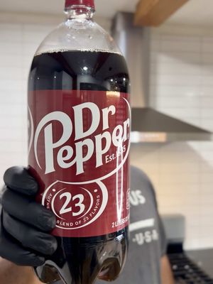 Y’all trust vending machines… I trust my stove. Homemade Dr. Pepper clears everything — tastes just like the real thing, only healthier. 🥤🔥  Inspo: @Skylar  Dr. Pepper Recipe Ingredients: 1 cup coconut sugar 1/2 cup water 3 cinnamon sticks 1-inch piece each of lemon, lime, and orange peel 1/2 tsp each: ground nutmeg, cloves, cardamom, ginger, star anise 1 tbsp fresh ginger 1 tbsp peppercorns 1 cup cherries 1 tsp bitters 1 tsp vanilla 1 tsp almond extract Instructions: Start by adding the coconut sugar to a saucepan over medium-low heat. The moment it starts to caramelize at the bottom of the pot, immediately but slowly pour in the water while stirring. Keep stirring and let the mixture come to a gentle simmer. Add the citrus peels, cinnamon sticks, ground spices, fresh ginger, peppercorns, cherries, and bitters. Let everything simmer on low heat for about 10–13 minutes, until the syrup thickens slightly and the flavors come together. Near the end of simmering, use a potato masher to gently mash the cherries and release all their juices into the syrup. Remove from heat, strain out the solids, and stir in the vanilla and almond extract. Transfer the finished syrup to a jar and store it in the fridge for up to two weeks. To serve: Mix about 3 tablespoons (or your desired amount) of syrup with seltzer water, or simply top it off to taste. Stir gently, then serve.  #drpepper #homemade #drinks #Recipe #foodtiktok 