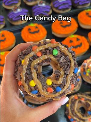 witch, please... i'll take a dozen! 🎃 Jack-o-Lantern: Shell doughnut decorated with orange and green buttercream and decorated with a Jack-o-Lantern face 🍬The Candy Bag: Original Glazed™ doughnut with chocolate buttercream, a sprinkle of trick-or-treat candy blend, and a caramel swirl 💚Spooky Sprinkle: Original Glazed™ doughnut dipped in green icing and topped with ghostly Halloween sprinkles 🌙 Cookies & Skreme House: Shell doughnut dipped in chocolate icing and silver chocolate cookie crumble, topped with purple icing and a spooky Haunted Mansion piece which one are you excited to try? #krispykreme #doughnut #halloween 