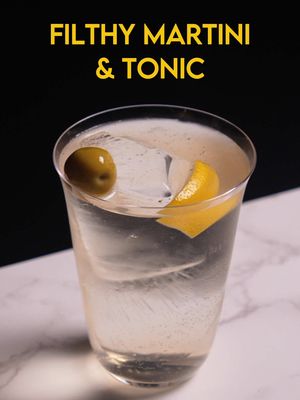 Filthy Martini and Tonic Olive Gin, Olive Distillate, Fino Sherry, Tomato Vermouth, White Balsamic Vinegar, Tonic Inspired by the dirty martini and tonic I had at Schmuck, this version is very olive forward, with even more savory ingredients to make it a whole meal. Vinepair did an interview with them to ask about how its made, and so I cobbled a recipe together based off that (minus the force carbonation, but I would love to do that in a next version) Olives come in 3 forms, a gin, a distillate, and brine, and those flavors are supplemented along side some fino sherry for minerality and tomato vermouth for more vegetal savoryness. White balsamic adds a bit of acidity, sweetness and fruitiness. If you don't have these ingredients, you can follow the template of 1.5 oz gin / 1.5 oz vermouth/ .5 oz brine/ 4 drops balsamic / 3.5 oz tonic, and you should be able to make your own version of a dirty martini and tonic. 0.75 oz Olive Leaf gin 0.75 oz Olive Distillate 0.5 oz fino sherry 1 oz Tomato Vermouth 0.5 oz olive brine 4 drops white balsamic 3.5 oz tonic build in a highball glass with ice, garnish with lemon peel and olives Alternatively, assemble everything but the tonic in one glass and pour into a highball glass over ice, then top with tonic and stir briefly. Garnish with lemon peel and olives. #fyp #cocktail #martini 