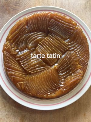 How to Make an Apple Tarte Tatin 🍎🍎🍎 NOTE: this is for a 9" cast iron skillet - measurements for a bigger/smaller pan will need to be scaled accordingly INGREDIENTS: 4 large honeycrisp apples 1 large sheet frozen puff pastry (thawed) 2/3 cup granulated sugar 1 tbsp apple cider vinegar  1 tbsp water 3 tbsp cold unsalted butter 250 mL 35% whipping cream 1 tbsp icing sugar 1 tsp cinnamon 1 tsp vanilla extract  INSTRUCTIONS: 1. Peel your apples, and cut each apple into 3 equal segments, removing the stem and core. Place your peeled apple segments in a large container or bowl, and submerge them with hot water from your tap. (Tap water at its hottest setting, is typically between 50-60 degrees Celsius, which is what we’re aiming for - if not, adjust the temperature as needed!). Let your apples sit in the water for at least 10 minutes, or until we are done the next step. 2. While your apples are soaking, make your caramel! Using a 9" round cast-iron pan (you can also use another pot/pan to make your caramel, then transfer it to a 9" round baking dish after). Cover the bottom of your pan with an even layer of your granulated sugar, then drizzle your 1 tbsp vinegar and 1 tbsp water to cover the sugar (add more water if needed to cover the sugar). Turn your stove top to medium heat, and allow the sugar to come to a boil, before reducing into a caramel. What you are looking for with your caramel, is for a light brown colour to appear. Once you see this (likely just in one section of your pan, VERY CAREFULLY tilt your pan in a circular motion to make sure the sugar caramelizes evenly - but DO NOT stir or whisk your caramel at any point, or else it will crystallize. Once your sugar is evenly caramelized everywhere (now a thick, syrupy consistency), stop the caramelization by stirring in your cold butter. At this point it is okay to stir, and you will continue stirring for 2-3 minutes, or until the caramel is thick and emulsified (see video for a visual). Remove your caramel from the heat. 3. Remove your apples from the warm water, and if you would like (this is completely optional), thinly slice your apples. From here, VERY CAREFULLY place your apples into your caramel, with whatever you consider to be the "presentation side" face-down in the caramel.  4. If you haven’t already, pre-heat your oven to 400 degrees Fahrenheit. Cut your puff pastry dough into a circle, *slightly* larger than the surface area of your pan. Place the pastry directly on the apples, tucking any excess dough around the edges of your apples. Poke holes in your dough using a fork, and then bake in the oven for 20-35 minutes (based on the exact heat of your oven this will vary). You will be looking for a nice golden brown crust, and for the caramel to be thick when you look around the edge of your tart (no liquid pooling when you look around the edge)  5. Remove the tart from the oven, and allow it to cool, in the pan, for 60-90 minutes. Once your pan is warm, but cool enough to handle with your bear hands, flip your tart onto a plate, cutting board, or better yet - a tray with a rack.  6. For your whipped cream, whip your cream, vanilla, icing sugar, and cinnamon until stiff peaks form. Slice your tart and garnish it with a generous dollop of your whipped cream. Enjoy! #apple #tartetatin #cooking #homecooking #Recipe