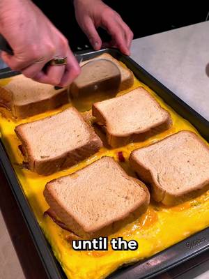 Sheet Pan Breakfast Sandwich INGREDIENTS 7-10 eggs 6 slices of bread 6 hashbrowns 1 sliced avocado 3 large sliced tomatoes 6 slices of smoked ham 6 slices of cooked bacon 1/4 cup garlic butter 12 slices of American Cheese  
