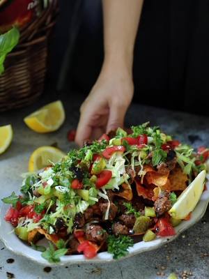 #AD I partnered with @flvr_global to create a new way to enjoy a Turkish mezze: Doritos Loaded Çiğ Köfte! There are so many layers of flavor, spice, and freshness, with Doritos adding the perfect crunch. Rotate, load Up, dive in and enjoy! #FLVR #Doritos #DoritosLoaded #Doritosrecipe Doritos Loaded Çiğ Köfte Ingredients: For the Çiğ Köfte: I lb (450g) çiğ köftelik bulgur 16 oz hot water 1 tbsp roasted beef bouillon 12 oz tomato paste 1 tbsp pepper paste 1 small onion, finely grated 2 medium garlic cloves, finely grated 1/3 cup olive oil 2 tbsp pomegranate molasses Juice of ½ a lemon 50g isot pepper (urfa biber) ¼ tsp ground cinnamon 2 tsp dried mint 2 ½ tsp cumin 1 tsp salt (more to taste) ½ tsp black pepper 2 sprigs fresh parsley, finely chopped For the Sauce: 2 tbsp pomegranate molasses 2 tbsp olive oil 2 tsp lemon juice 1 tbsp ketchup ¼ tsp black pepper 2 tbsp isot pepper (urfa biber) For Assembly: 1 bag Doritos 1 cup iceburg lettuce, shredded 1 medium tomato, diced 2 tbsp dill pickle, diced 2 tbsp green onion, chopped 1 sprig parsley, chopped Fresh mint leaves 2-3 lemon wedges Instructions: Prepare the Çiğ Köfte: In a large jar, add hot water and bouillon, stirring until the bouillon is dissolved. In the bowl of a stand mixer or a food processor, add bulgur and immediately add the hot water mixture to the bulgur. Cover with lid and allow to soak for 10 - 15 minutes or until all the water is absorbed. After the bulgur is soaked, add all the çiğ köfte ingredients except for the parsley. Use the paddle attachment of your mixer or pulse your food processor to mix the ingredients for 15 -20 minutes, or until it resembles a thick, moldable paste, as in the video. Add the parsley and continue to mix for a few minutes until it is fully incorporated. Using your hands, take small pieces of the çiğ köfte mixture and make a small, oblong shape, pinching your fingers to shape it in the traditional form, as in the video. Prepare the Sauce: In a small bowl, add all of the sauce ingredients and mix with a spoon until combined. Assemble the Doritos Loaded Çiğ Köfte: On a serving plate, place a layer of Doritos evenly. Add the prepare Çiğ Köfte on top of the Doritos. Drizzle some prepared sauce over the Çiğ Köfte. Repeat with another layer of Doritos, Çiğ Köfte, and sauce. Then, top with lettuce, tomato, dill pickle, green onion, parsley, and mint. Serve with lemon wedges on the side. Bon appetit!