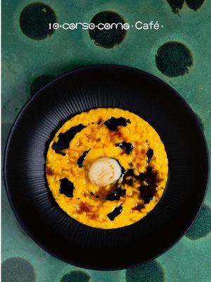 Halloween by 10 Corso Como Café     The 10 Corso Como Café is the ideal place to celebrate the ghostliest night of the year, savoring a special cocktail and a unique dish created for the occasion. A Milanese risotto reimagined with pumpkin and saffron, enhanced by a Campari reduction, squid ink-infused brown stock, and a grilled scallop. Paired with a cocktail that blends the warmth of bourbon whiskey with spiced pumpkin, bright citrus notes, and an unexpected finish of white chocolate and activated charcoal. Book a table on 10corsocomo.com 