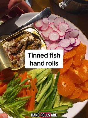 Here's how to make Tinned Fish Hand Rolls: • 1½ cups sushi rice, rinsed well • ¼ cup seasoned rice vinegar • 1 tablespoon finely chopped ginger • 4 roasted sushi nori sheets, quartered • 4 tins of fish (about 4 ounces each), such as mackerel or sardines • Any combination of sliced cucumbers, radishes, baby carrots, clementines and scallions • Soy sauce or ponzu, for serving In a medium saucepan, bring the rice and 2 cups of water to a boil. Cover, reduce heat to low and cook until tender, 18 to 20 minutes. Remove from heat and let sit, covered, for 10 minutes. (This is a good time to slice your toppings.) When the rice is ready, drizzle with vinegar and top with ginger. Stir with a spoon to combine. (The rice, as well as the sliced toppings, can be transferred to airtight containers, covered with damp towels and refrigerated for up to 3 days. Bring the rice to room temperature before eating, or warm in the microwave.) To build hand rolls, top nori with some rice, fish and any of the raw toppings. Drizzle with soy sauce or ponzu, wrap and enjoy.
