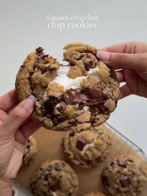 S’mores chocolate chip cookies  Ingredients  1/2 cup (113g) salted butter, melted  1/3 cup (67g) granulated sugar  1/2 cup (100g) dark brown sugar  1 tbsp (15g) vanilla bean paste  1/2 tsp espresso powder  1 1/4 (156g) cups all purpose flour  1/2 tsp baking soda  1 egg, room temp 1 cup (170g) semi sweet chocolate chips  1/2 cup (85g) mini chocolate rectangles 8 large marshmallows  8 square of graham crackers  Method: Preheat the oven to 350 F. Prepare a baking sheet with parchment paper and set aside. In a bowl, add melted butter granulated sugar, and brown sugar. Mix for 2 to 3 minutes until well combined crack in the egg and whisk for 1 to 2 minutes until smooth add in vanilla Bean paste and mixed to combine. In a separate bowl, combine all purpose, flour, baking soda, and espresso powder mixed well to combine. Gradually incorporate the dry ingredients into the wet batter until they are just combined. add the chocolate chips and mix them just to combine , avoid overmixing the batter. In the prepared baking sheet add graham cracker squares top them with the chocolate rectangles . Add marshmallow on top. Finally, scoop out a portion of cookie dough, flatten it slightly, and place it on top of the marshmallow, covering it completely. Place 3-4 cookies on one baking sheet placing them 2-3 inches apart. Bake the cookies for about 12-13 min or until the edges are golden and crispy and center is chewy and soft. Let cool completely for 25-30 min before serving and enjoy. #cookie #cookies #smorescookies #Recipe 