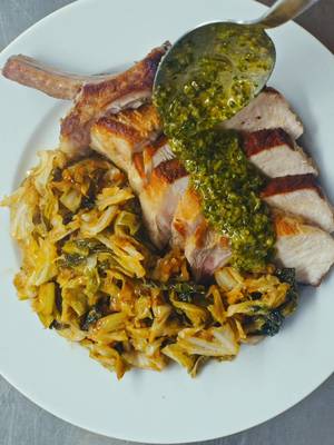 Pork and Cabbage - Another Day In Paradise  Pork and cabbage is a perfect combination - whether it’s a ham hock and cabbage soup, pork and cabbage dumplings, or this bone-in pork chop with sautéed cabbage and salsa verde. It’s humble, comforting, and something I love to cook for myself. You can find the full recipe on my newsletter 🫶🫶