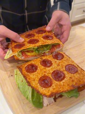 This is actually insane! Crunchy Pepperoni Wrap ⬇️Recipe ⬇️ mozzarella cheese pepperonis Romaine lettuce Turkey Tomatoes  Banana peppers  Chipotle mayo Line baking sheet with parchment paper. Spread mozzarella evenly across tray. Add pepperonis. Place tray in the oven at 350 and bake for 15 or so minutes or until the edges have browned. Remove tray from the oven and let sit to cool and harden for 5 minutes. Lift wrap and flip it over. Add inside ingredients then fold it over. Cut in half and enjoy! #cooking #dinner #Recipe #food #husbandandwife 