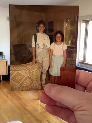 The number one question I get about buying my childhood home is: What are you going to do with a second house? Rent it? Airbnb it? Flip it? Nope. I’m keeping it just for me. Unless you’re in The Dead Sibling Club, this decision is difficult to understand . Last month is/was my sister’s birthday. She would have been 46. It’s been almost 20 years. A few weeks ago, my parents and I finally spread her ashes. We never knew where the “right place” was… until now. Since I bought the house, my mom suggested we sprinkle her in the backyard. It felt right. I somehow got nominated to open the box (10/10 do not recommend being the opener when you don’t know what to expect). But we did it. And the next day, she let us know she approved. If you’ve read my blog post about her death, you know about the feathers. They’ve always shown up at the exact moment I need her. And the morning after we spread her ashes, my parents texted me: the entire back patio was covered in tiny white feathers. Not a few. Dozens. Everywhere. I watched my dad on the Ring camera… he stopped, looked around, laughed, and just shook his head. My mom came out like, “Well for heaven’s sake.” We all took it as her saying, “Thank you. I’m home.” Last year was… rough. So if I’ve been quiet, that’s why. A lot of big life shifts. Buying this house was emotional in ways I didn't expect. My parents moved to Florida. I’m figuring out my new normal. Grateful for The Boy and my kiddos. ANYHOO, here’s a then-and-now of the house. I’ve always wanted to share one. And if you’re still here, I could use some decorating help. The living room (with the funky chrome couch) used to have wood paneling—I’d love to bring that back. Anyone have a source for mid-century modern book-matched wood veneer paneling? Also window treatments are breaking my brain. These smaller MCM windows need heat control, but I’m torn—blinds? Curtains that skim the floor? Sheers layered? The bay window? Valances—keep? Extend? Help a girl out and if you made it this far, thanks for reading. ♥