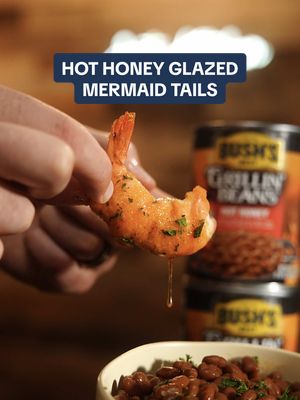 #BushsBeansPartner Hot-Honey Mermaid Tails paired with… beans?  I promise, the marriage of flavors between these hot-honey mermaid tails and Bush’s Grillin’ Beans with Mike’s Hot Honey will be loved by everybody at the tailgate 🧜‍♀️🫘   Full recipe:  🔸Salmon  🔸Large Shrimp  🔸Cream cheese  🔸Seasoning of your choice  🔸 @Bush’s Beans Grillin’ Beans with Mike’s Hot Honey  🔸 @Mike’s Hot Honey    🔹 Thinly slice strips of salmon and coat 1 side with a thin layer of cream cheese. Wrap it around some cleaned and de-veined shrimp but leave it on the tails for something to hold onto.   🔹In an oven safe dish, arrange your mermaid tails and season. Set aside and prep your beans.  🔹 Open 2-3 cans of Bush’s Grillin’ Beans with Mike’s Hot Honey and pour into an oven safe dish.   🔹In the smoker, oven or grill at 325°, place in your beans and mermaid tails.   🔹Depending on the size of your shrimp, heat for about 20 minutes and then glaze your mermaid tails with hot honey.  Let it cook for another 5 minutes.   🔹Stir your beans and remove from heat.  Would you try these?  #ad #seafood #grilling #tailgate 