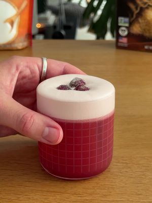 Who wants a cranberry cinnamon sour? 🍒 This festive cocktail is as cozy as it is vibrant — the perfect balance of tart cranberry and warm cinnamon. It’s a great sip before Thanksgiving and Christmas (just… maybe steer clear of your white furniture 😉). Ingredients (per serving): - 1 egg white or aquafaba  - 2 oz gin - 3/4 oz lemon juice - 3/4 oz cranberry juice  - 1/2 oz cinnamon syrup (recipe below) - coated cranberries to garnish (recipe below) Combine ingredients in a cocktail shaker and dry shake to start — this creates the foam. Then add your ice and shake vigorously. Strain into a coupe glass and garnish with coated cranberries. Enjoy! ——— Cinnamon syrup: - 1 cup Sugar @In The Raw  - 1 cup water - 4 cinnamon sticks - dash of vanilla if desired  Combine sugar and water and boil until the sweetener dissolves. Reduce to a simmer and add cinnamon sticks — simmer for 5min. Let cool completely (about an hour) then strain. Coated Cranberries: Combine a handful of cranberries, Hot Agave In The Raw and Monk Fruit In the Raw. Toss until cranberries are fully coated with the sweetener. *I doubled the ingredients in the video shown* #holidays #cocktails #holidaycocktail #cocktailrecipe #holidayrecipe 