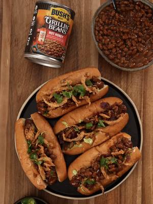 Sweet, spicy, and crunchy; meet my sweet heat crunch dog! #BushsBeanPartner Topped with avocado cilantro sauce, crispy onions & beef bacon bits, and leveled up with @Bush’s Beans for the ultimate game day main. You’ll be the star of any tailgate this season     Ingredients  For the Hot Dog:  4 chicken sausages, cross-hatched  4 hot dog buns, toasted  1 can Bush’s Grillin’ Beans with Mike's Hot Honey  1 pack of beef bacon, cooked until crispy and chopped or already made bits  For Crispy Fried Onions:  2 large onions, thinly sliced  1 cup buttermilk  1–2 tsp hot sauce  Dredge:  ¾ cup all-purpose flour  ¼ cup cornstarch  1 tbsp garlic powder  1 tbsp onion powder  ½ tbsp chili powder  ½ tbsp smoked paprika  Salt & pepper  Canola oil, for frying  For Avocado-Jalapeño-Cilantro Sauce:  ½ cup mayonnaise  3 cups lightly packed fresh cilantro (mostly leaves; small stems ok)  1 medium jalapeño, seeds and membranes removed but reserved, roughly chopped  4 cloves garlic, roughly chopped  Juice of 2 limes  Sea salt, to taste  Fresh cilantro leaves, for garnish  