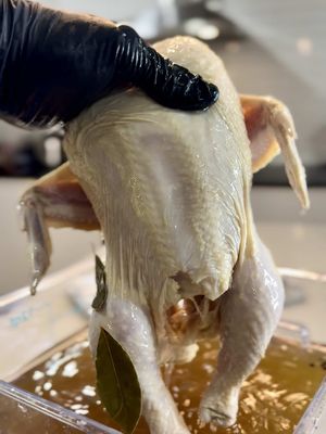 Every year folks swear their turkey’s “juicy,” but you can hear that dryness in every bite. 😩 You can baste it, butter it, or drown it in gravy — but if you didn’t brine it, that flavor never had a chance. This ain’t overdoing it — this is understanding science and soul. Salt, citrus, herbs, time… that’s how you make every bite hit from skin to bone. Call it “extra” if you want, but I call it care 🤌🏾 Turkey or Chicken Brine (5-15 lb Bird)  Items & brine ingredients you will need: Extra Large Cooking Pot 12 Quart Clear Square Polycarbonate Food Storage Container w/ Lid 24 cups of Water  (1) 5 lb bag of Ice 2 cups of Kosher salt  2 cups Apple Cider Vinegar  1/4 cup of Worcestershire  3 tbsp Peppercorns 10 cloves of Garlic (minced, chopped or smashed)  1 Lemon Cut into Wheels  2 Oranges Cut into Wheels  “The Green Goddess” – a few sprigs of Thyme, Rosemary & Sage 4 Bay leaves  We are going to start off with boiling 12 cups of water in a pot.  Once the water comes to a rolling boil, add the brine ingredients into the pot and continue to boil for 7-10 minutes to dissolve the salt and release all of those aromatics from the herbs.  Turn the heat off after 10 minutes of boiling.  Pour the hot brine from the pot into the polycarbonate container then add the remaining 12 cups of cold water and ice to cool the brine down to room temperature. This step may take about an hour or longer. The water MUST be cooled down to room temperature.  Once the brine has cooled down to room temperature, drop your chicken or turkey in and refrigerate for 6 to 24 hours. Once you have completed the brining process, remove the chicken from the brine and give it a good rinse with cold water to wash off any remaining salt or brining ingredients from the container. YOU MUST RINSE IT OFF. The salt will carry over if not rinsed off.  Pro Tip: White or brown sugar is common, but optional. And the great thing about a brine is that it is completely customizable. #turkey #chicken #thanksgiving #food #foodtiktok 