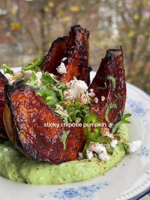 Sticky chipotle pumpkin on the creamiest avocado and jalapeño sauce ✨ RECIPE ½ crown prince pumpkin Extra virgin olive oil Flakey salt 3 tbsp chipotle paste 3 tbsp agave 1/4 orange zested ½ lime, juice 1 garlic clove, grated 1/2 tsp ground cumin ½ tsp smoked paprika 1 tsp soy sauce Salt and freshly cracked pepper, to taste 15g fresh coriander (stems included) 100g thick vegan greek yoghurt ½ avocado ½-1 fresh jalapeno 1 spring onion, greens only Salt to taste To garnish: A handful coriander, finely chopped Thinly sliced jalapeño 50g vegan feta, crumbled Tajin 1. Preheat the oven to 180 fan or 200C. Take half the squash and remove the seeds. Cut it into 4-5 thick wedges, leaving the skin on. Place the wedges onto a tray, drizzle with a splash of oil and salt then place into the oven to roast for 45-50 mins. 2. Whisk together all the ingredients for the glaze. After 45 minutes baste the squash wedges with the sticky glaze. Repeat again after 10 mins then switch to grill/turn the heat up to caramelise the sauce. Baste as many times as you want to get a nice thick coating of the sauce. 3. Blend the ingredients together for the avocado crema and season to taste. 4. Spoon the crema onto a plate, place the pumpkins on top and top with the garnishes.  #pumpkin #squashrecipes #easyveganmeals 