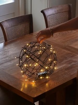 One of my favourite and one of the easiest DIYs ever with the biqgest impact!     All you need are some wire flower baskets, cable ties and some battery remote controlled fairy lights which are suitable for outdoor use. I used two different sizes of flower baskets to add a bit of interest. Would you try this? #christmasdiy #Christmasdiydecor #christmasideas #christmasdecor #christmaslights 