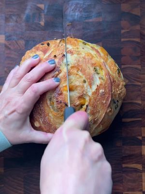 I accidentally added 170 grams of starter to my sourdough instead of my usual 100… and honestly? Best. Mistake. Ever. The rise was insane, the flavor was so much deeper, and the crumb? I AM OBSESSED. Between the extra starter and doing two full minutes of stretch + folds every 30 minutes, this loaf might be my new favorite. Here’s my updated “basic” recipe for two loaves: 720 grams water 170 grams sourdough starter 20 grams salt 1000 grams unbleached white flour Mix everything together. Cover and stretch + fold every 30 minutes (4 rounds). I usually do this before bed and let the dough proof overnight on my counter, covered. In the morning, refrigerate for 6 hours. Heat your Dutch oven with the lid on for one hour at 450°F. Divide the dough (I add inclusions right before baking). Bake for 30 minutes with the lid on. Remove the lid and bake for another 15 minutes. Let cool completely before slicing. Torture, but worth it! I’m filming a full YouTube video soon so you can follow along step by step. Stay tuned! Have you made sourdough yet?