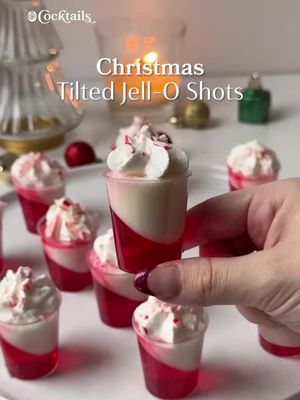 Two flavors are better than one ✨❤️.  Recipe inspo: @Champagne Ang  Strawberry Layer: -3 oz. strawberry Jell-O mix -1 cup boiling water -1/2 cup vodka -1/2 cup cold water White Layer: -7 oz. sweetened condensed milk -1 cup boiling water -1 packet gelatin Garnish: -whipped cream -crushed candy canes #tiltedjelloshots #christmas #peppermint #candycane #jelloshots 