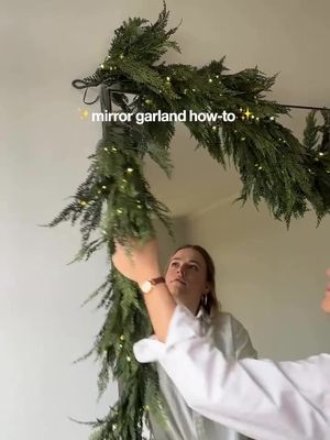Before you learn how to style our stunning Hemlock garland, keep reading for our top two tricks, and comment “Garland” for the link to save 20% for Black Friday!* ✨ 1. Place a removable hook near the top left corner of your mirror to secure the garlands. ✨ 2. Want to add floral picks like we did? Bend the stems so they easily hook onto the garland. *Terms apply. #Garland #HolidayDecorating #HolidayHowTo