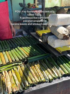 Filipino delicacy - tupig. Glutinous rice cake with coconut wrapped in banana leaves and smoked over charcoal.  #filipinofood #philippines #foodreviews #traveltiktok #foodietiktok 