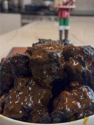 Oxtails don’t rush. Neither should you.Low heat. Long hours. Real love. 🤎🔥 Oxtails (6–8 lbs) Seasoning 3 tsp allspice 5 fresh thyme sprigs 10 garlic cloves, minced 1 bunch scallions, diced ½ onion, diced 3 tbsp ketchup 3 tbsp browning 1 tbsp paprika 2 tbsp all-purpose seasoning 1 tsp Badia Complete Seasoning 1 tbsp coarse black pepper 3 tsp kosher salt 3–4 Scotch bonnet or habanero peppers, finely chopped (seeds in or out, your preference) Season Pat oxtails dry. Toss with all seasoning ingredients until fully coated. Cover and refrigerate 4–24 hours. Braising 4 tbsp olive oil 1 large onion, quartered 3 celery ribs, diced 3 carrots, diced 2–3 tbsp tomato paste 2 cups red wine (Cabernet) 6–7 cups beef broth 4 bay leaves Braise Heat olive oil in a large pot over medium-high heat. Sear oxtails on all sides until deeply browned; remove and set aside. Scrape up the browned bits on the bottom (do not discard). In the same pot, sauté onion, celery, and carrots; stir in tomato paste. Lower heat, deglaze with red wine, then add beef broth. Return oxtails to the pot, add bay leaves. Cover and simmer on low 3½–4 hours, until fork-tender. Gravy Strain the braising liquid. Wipe out the pot to remove any vegetable debris. Add the liquid back and bring to a simmer. Whisk in 3 tbsp dry roux or flour, stirring continuously until thickened to your desired consistency. Finish Taste the oxtails and add a pinch of salt if needed. #oxtail #Recipe #beef #food #cooking 