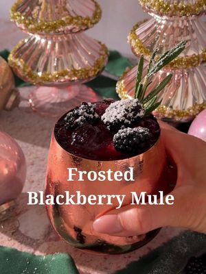 Frosted Blackberry Mule ❄️☃️ 6 blackberries  .75 oz lime juice  2 oz vodka  3-4 oz ginger beer Powdered sugar for topping  Blackberries and a rosemary sprig for garnish  Start by muddling blackberries and lime juice in a cocktail shaker. Add vodka and ice and shake until cold. Strain into a copper mug filled with crushed ice. Top with ginger beer and garnish. Use a small-mesh strainer to sift the sugar on top.  #holidaydrinks #HolidayRecipes #cocktailrecipes #cocktail #drinksathome    