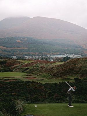 Here are 3 reasons Royal County Down is regularly rated as the best golf course in the world: Location 📍 The course sits at the foot of the Mourne Mountains which bloom a lush green and purple in summer and offer a moody dramatic backdrop in the winter. To the right of the opening holes is Dundrum Bay, a 5 mile stretch of beach ready to catch errant tee shots. Holes run through channels that sit deep below the dunes, giving views of nature at every angle. History 🕰️ Back in 1889 the railway arrived in the town of Newcastle and a group of Belfast businessmen were eager to capitalise on the new infrastructure. Scotsman George Baillie laid out the initial 9 holes and shortly after that Old Tom Morris was given the call to advise on a second nine. From then on, a who’s who of course architects visited and advised on the development of the site, from JH Taylor to Harry Colt. Signature Holes ⭐ The 200 yard par 3 4th is the first jaw dropper as you turn to face the mourne mountains. Linear grass paths guide your eye to a green surrounded by 9 pot bunkers. The 9th gets the headlines though, where the view from the top of the hill looks down to a fairway punctuated by heather covered mounds, the pink spire of Slieve Donard adding a mystical touch.