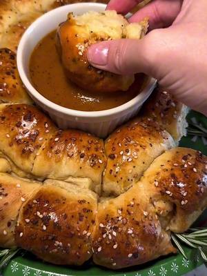 Move over pigs in a blanket, Santa's new favorite app is beef in a wreath! See the recipe below for this Holiday meatball wreath 🎀🎅🎄 INGREDIENTS: 2 pkgs crescent roll dough (approx.) Dijon mustard 1 pkg of your favorite Simek’s meatballs 1 egg (for egg wash) 2 tbsp Everything Bagel seasoning Honey mustard or your favorite dip (for serving) Rosemary sprigs for garnish (optional) DIRECTIONS: Preheat oven to 375F. Roll out the crescent dough onto a clean surface and pinch the seams together. Brush a thin layer of Dijon mustard over the entire surface of the dough. Cut the dough lengthwise into four strips. Cut the dough vertically into thirds. Place one meatball on each strip of dough. Roll the dough around the meatball, ensuring the dough wraps snugly. Line a large baking sheet with parchment paper. Arrange the wrapped meatballs in a circular wreath shape on the baking sheet, ensuring the sides are touching. This will help the wreath hold its shape while baking. Whisk the egg and brush the egg wash generously over the dough. Sprinkle the Everything Bagel seasoning over the top of the wreath for added flavor and texture. Bake the wreath for 20–25 minutes, or until the dough is golden and puffed. Remove the wreath from the oven and let it cool slightly. Transfer your wreath to your serving platter. Serve warm with honey mustard or your favorite dipping sauce in the center of the wreath. Optional: add sprigs of rosemary around your wreath to give it an even more festive look.