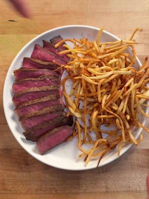 Steak Frites with Cowboy Butter!  Frites  3 large russet potatoes, peeled and cut shoestring style 2 qt ice water 1.75 qt vegetable oil for frying Kosher salt Cowboy Butter sauce 2 stick unsalted butter The zest and juice of 1  lemon 6 cloves garlic, minced finely  2 Tbsp dijon mustard  1  Tbsp smoked paprika 1 tsp cayenne pepper powder 3 Tbsp fresh parsley, finely chopped   2 Tbsp chives, thinly sliced 1 Tbsp fresh horseradish, grated 2 tsp worcestershire sauce Salt & pepper to taste  Steak 2 ribeye or new york steaks (at least 1 inch thick) Kosher salt Black pepper 2 Tbsp avocado oil 4 Tbsp unsalted butter 3 cloves smashed garlic 1 small bunch fresh thyme 3 sprigs fresh rosemary For garnish  Flaky salt Sliced chives Prep your potatoes, to start, peel and cut your potatoes into planks, take those planks and slice them long ways into shoestring strips.   In a large bowl add the sliced potatoes and cover with ice water. Mix well to rinse the starch.  Add a towel to a sheet tray, add your potatoes on top and dry very thoroughly. First fry, in a medium pot, heat the vegetable oil until 325°F. Once the oil is hot, fry your potatoes in batches until cooked through but not golden. 2-3 minutes. We will fry them again so dont worry about getting them crispy. Drain on a wire rack and repeat with all your potatoes.  Make the cowboy butter, in a small pot over low heat gently melt the butter. Once melted add lemon zest and juice, garlic, dijon, smoked paprika, cayenne, parsley, chives, horseradish, salt & pepper. Mix to combine and keep over very low heat until needed. (dont let it break) Prep the steak, pat the steak very dry with a paper towel and season the steak generously with salt and pepper on both sides.  Cook the steak, heat a 10 inch frying pan over medium high heat, once very hot add the avocado oil followed by the steaks. Press firmly into the pan to get full contact and cook for 2-3 minutes until a deep golden crust forms then flip turn the heat to medium and add the butter, garlic, thyme and rosemary. Tilt the pan so the butter pools and repeatedly baste your steak until cooked to your desired doneness. Remove to a wire rack to cool.   Rest the steak for at least 8 minutes while you fry the potatoes for the second time. Heat your oil to 375°F.  Fry your potatoes just until golden 2ish minutes. Remove to a wire rack and season generously with kosher salt.  Once your steak has rested, sliced ½ inch thick.  On a plate add sliced steak slightly offset.  Fan it out so it looks nice, add a generous amount of fries on the side and generously drizzle your cowboy butter nicely over the steak. Garnish with sliced chives and enjoy!