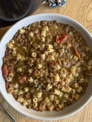 Are you eating lentils for good luck?  Pasta e Lenticchie 🇮🇹 In Italy, they say to eat lentils on New Year’s for good luck and prosperity because they look like tiny ancient coins. Beyond the tradition, this is a true Blue Zones longevity recipe. It's the kind of simple, one-pot weeknight dinner that helps you live to 100. It’s rustic, humble, and proof that you don't need much to make something that is good for you. Nonna would approve of this Lentil Soup! Ingredients: 8oz Ditalini pasta 1.5 cups dried lentils (rinsed) 12oz cherry tomatoes (quartered) 3 cloves garlic Fresh parsley Olive oil Sea salt Black Pepper Directions: 1. In a large pot, sauté olive oil, garlic, and tomatoes until fragrant and the tomatoes start to sweat. 2. Remove the garlic cloves. 3. Add the rinsed lentils and enough water to cover them by about an inch. Season with salt and pepper. 4. Cover and simmer for 30 minutes. 5. Check the water level (add more if it’s looking thick) and stir in the pasta.  6. Cook for an additional 10 minutes until the pasta is al dente. 7. Finish with fresh parsley and a little olive oil. #lentils #soup #fyp 