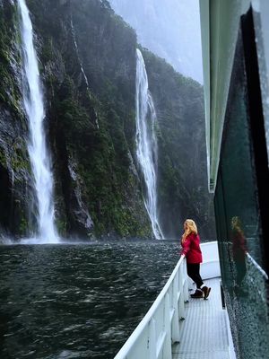 Bucket list New Zealand cruise details 😍👇 🌧️ Send this to your travel buddy! 💦 Did you know you can cruise through Milford Sound, one of the wettest places on Earth, and also one of the most famous fjords in the world? Each year the 20–23 feet of rainfall creates hundreds of waterfalls that cascades down sheer cliffs creating a land of waterfalls.  Cruising through this fjord is hands-down one of the most breathtaking experiences in New Zealand! 🌊🏔️ 🌊 This experience was MAGICAL- even in the rain! Passing towering cliffs, dramatic waterfalls, and misty rainforest while spotting wildlife like seals and dolphins… this is truly one of the most unforgettable natural adventures in the world. DETAILS BELOW 👇 🏷️ Price: We paid around $110USD per person with @cruisemilford  ⏱️ Time: Trips typically last 1.5–2 hours on the water. ☔️What To Bring: Rainwear (jacket and pants) and camera. Who would you cruise Milford Sound with?! 🛳️💙 #newzealand #milfordsound #newzealandtrip #bucketlist #naturelovers 