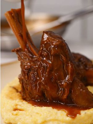 BRAISED LAMB SHANKS Slow cooked until fall off the bone tender. Served with Parmesan polenta, you really can’t go wrong. Satisfying and honestly not that hard to make. Full recipe below. ⬇️  Recipe, LAMB SHANKS – INGREDIENTS 3 lamb shanks Neutral oil, as needed Salt, to taste Black pepper, to taste 1 carrot, small dice 1 onion, small dice 1 celery stalk, small dice 2 tablespoons tomato paste 2–3 cups chicken stock 1 cup concentrated beef stock or beef stock concentrate 2 sprigs thyme 1 sprig rosemary 2 bay leaves LAMB SHANKS – METHOD Season lamb shanks lightly with salt and black pepper. Drizzle with a touch of neutral oil. Sear lamb shanks heavily in a hot Dutch oven until browned on all sides. Remove and set aside. Add diced carrot, onion, and celery to the pot. Sweat until softened. Add tomato paste and cook until toasted and caramelized. Deglaze with chicken stock, scraping the bottom of the pot. Add concentrated beef stock, thyme, rosemary, bay leaves, and a pinch of salt and black pepper. Return lamb shanks to the pot. Cover with a lid and braise in a 325°F oven for 3 hours. Remove from oven and rest lamb shanks for 15–25 minutes. Remove lamb shanks from liquid. Strain braising liquid and skim off excess fat. Reduce liquid until glossy and slightly thickened. Return lamb shanks to the pan and glaze in the sauce. PARMESAN POLENTA – INGREDIENTS 2 cups water 2 cups milk 1 cup coarse cornmeal 1/4 cup butter 1/2 cup grated Parmesan cheese Salt, to taste Black pepper, to taste PARMESAN POLENTA – METHOD Bring water and milk to a gentle simmer. Whisk in cornmeal gradually. Cook, stirring frequently, until tender and thick, about 25–30 minutes. Finish with butter and Parmesan. Season with salt and black pepper. #lambshanks #polenta #EasyRecipes 