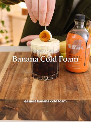 This is Aussie nostalgia in a cup. Pour it, Mix it, Hack it! This Caramel Banana iced coffee uses NESCAFE Espresso Concentrate Rich Caramel to pair perfectly with the banana cold foam.  #icedcoffeeicedcoffee #nescafecoldhacks #pouritmixithackit #coffeetok #nesquik